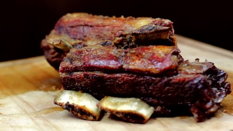 Roasted Beef Rib totating in a wooden board