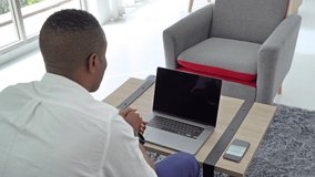 Business black american man, African person working from home on table with computer notebook laptop and blank screen space on webcam video call conference in quarantine in corona virus concept.
