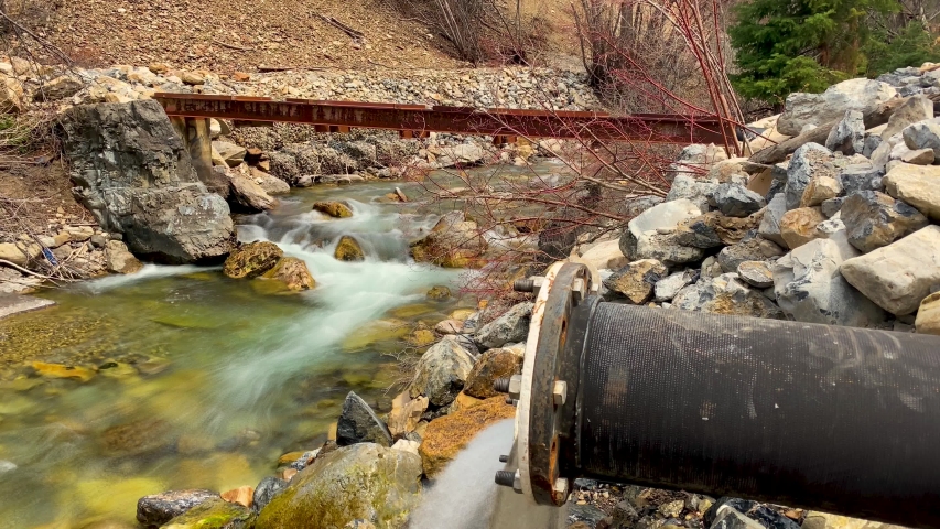 Long exposure time lapse of a river flowing down a mountainside - white water is smooth wispy and surreal