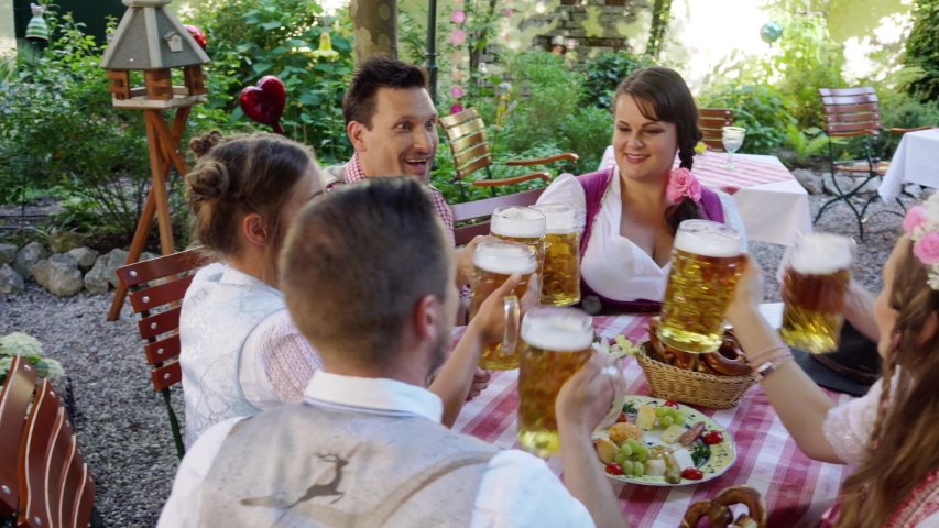Toasting in Bavarian beer garden, close-up on the glasses Royalty-Free Stock Footage #1055076383