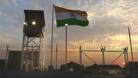 Waving flag of India above military base in the evening