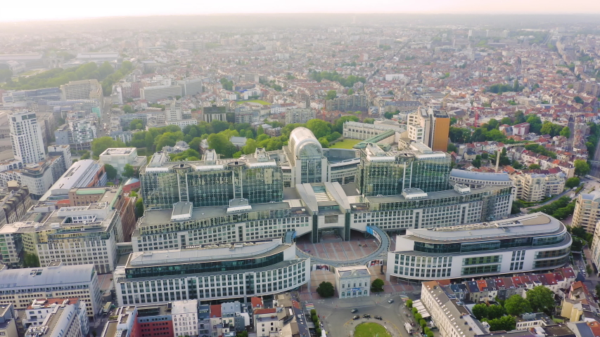 Inscription on video. Brussels, Belgium. The complex of buildings of the European Parliament. State institution. Neon white effect text, Aerial View, Point of interest