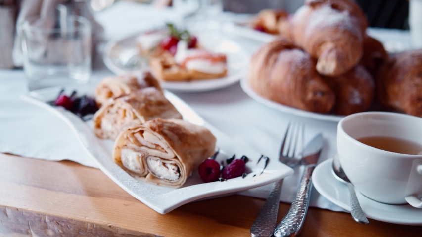 Abundant restaurant food table with delicious pancakes, croissants, pastries. Continental morning breakfast in all inclusive hotel resort. Royalty-Free Stock Footage #1055087777