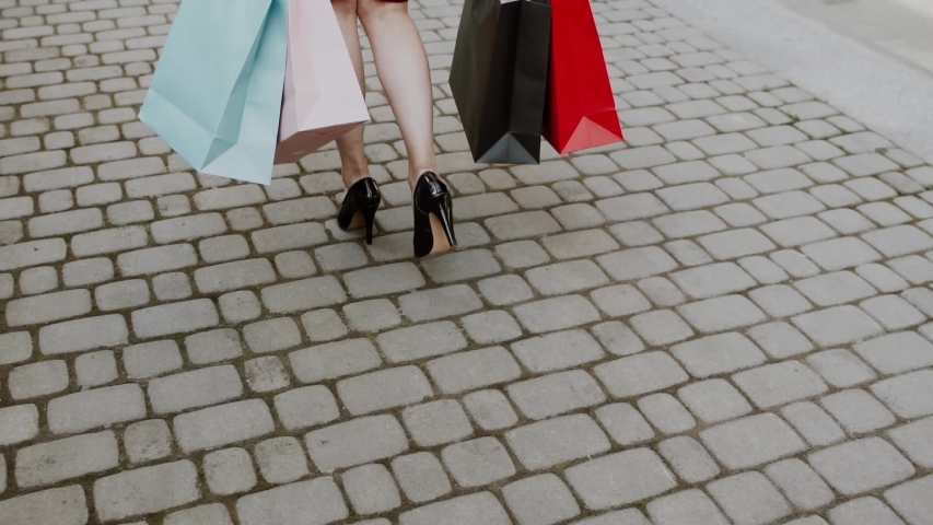 Pretty young woman walking in the city with her shopping bags.Shopping concept
