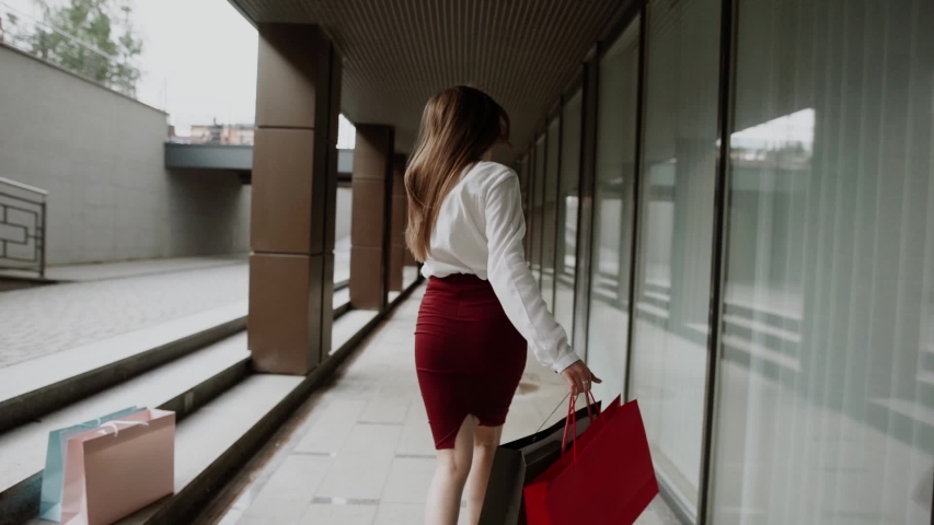 Pretty young woman walking in the city with her shopping bags.Shopping concept