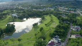 Aerial drone footage view putting green and beautiful turf golf course in Kota Kinabalu, Sabah, Malaysia in 4k Resolution - Powered by Shutterstock - Get 15% off with code: PIKWIZARD15