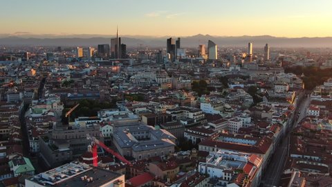 milan city aerial view drone of business district porta nuova at sunrise,skyscrapers with mountain in the background