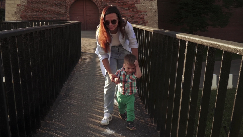 Boy with mom on a bridge of an ancient fortress in Nizhny Novgorod