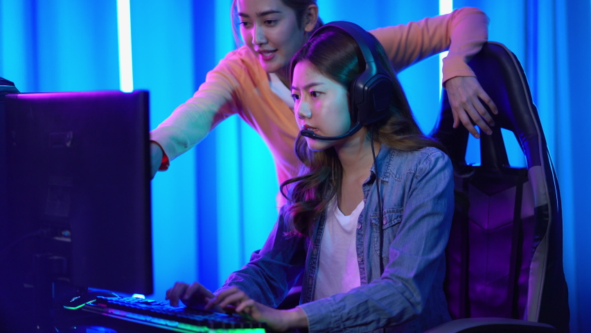 Young asian team woman gamer playing get lose video games on a computer 4K resolution
