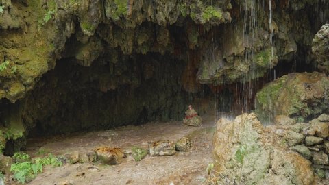 Shiva lingam in wild cave with waterfall