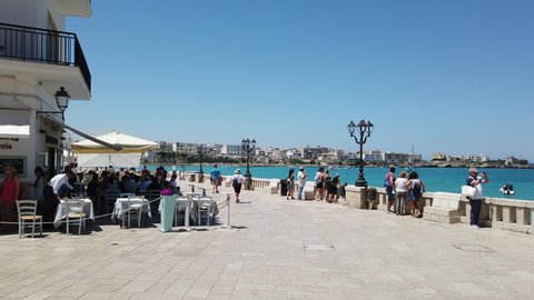 Tourists walking on the seafront of the heroes of Otranto, Salento, Puglia, Italy - 28/06/2020