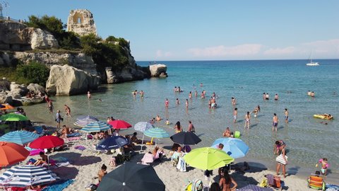 Beach full of bathers in June in Torre dell'Orso, Melendugno, Salento, Puglia, Italy - 28/06/2020