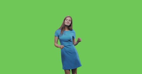 Happy smiling woman in blue dress dancing and having fun isolated on Green Screen, Chroma Key. 4k raw video footage slow motion 60 fps