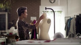 Fashion Designer draping a mannequin. Small business creative at work. Diversity and authentic artisan. Shot in 4k and in slow-motion.