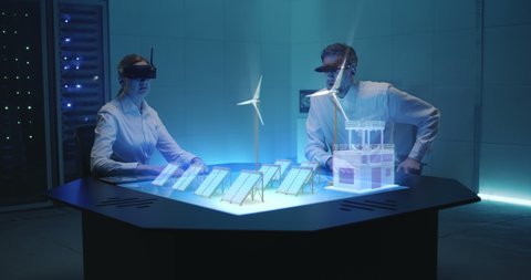 Engineers, designers, architects create a project of an eco-friendly power plant using a holographic table and virtual reality headset for visualization