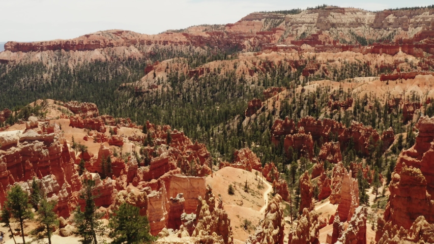 Cinematic aerial of Bryce Canyon National Park, red rocky spires, natural phenomena, landscape of another planet, scenic Utah