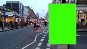 4k footage of a green screen billboard on the street. Screen replacement for advertising by chroma key video editing