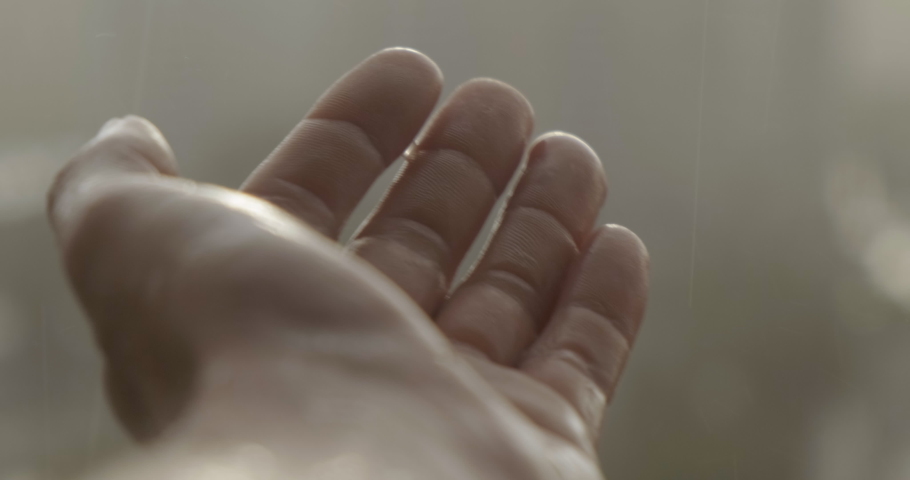 Male Hand Under Heavy Rain Close Up. Catches RainDrops on Palm. Hand Turns. Summer Warm Rain. Abstraction. Abstract Plan. Enjoying Weather. Wet Skin on Hand. Blurred Background. Part of Body | Shutterstock HD Video #1055137454