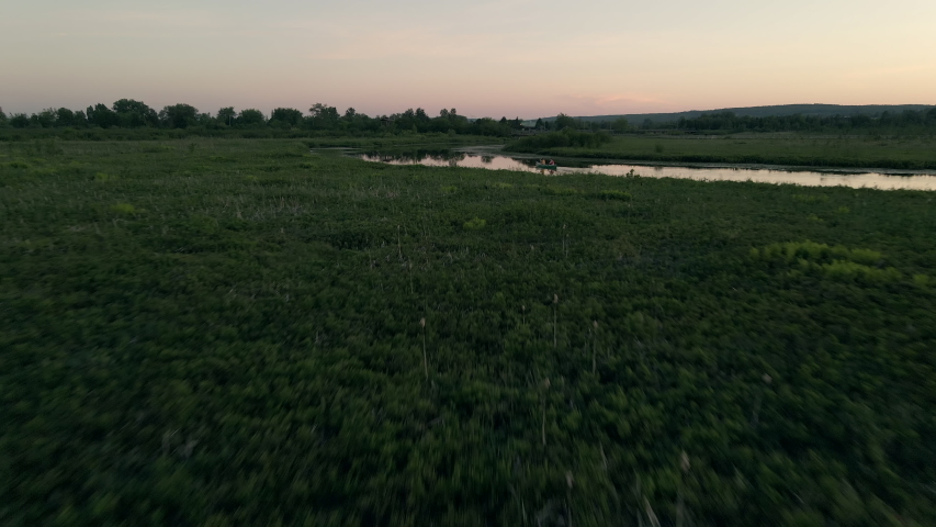 Flying Over The Cherry River And Wooden Boardwalk During Sunset Time In Magog, Quebec, Canada. - aerial drone