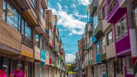 timelapse of set of colorful houses in the city of bogota, clear blue sky, people transit part 2