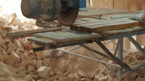 Closeup of cut pine tree log on sawing machine at wood production factory. Timber material processing and cutting at sawmill. Manufacturing process at lumber mill. Sawing woods on power machine