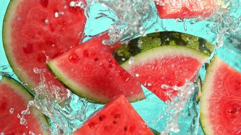Super Slow Motion Shot of Falling Fresh Watermelon Slices into Water