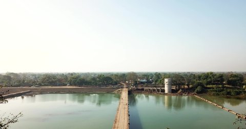 Footbridge Over The Calm Lake In Chhattisgarh, India - aerial drone