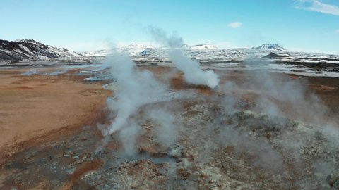 Namafjall Hverir geothermal area in Iceland. Stunning landscape of sulfur valley with smoking fumaroles and blue cloudy sky. Aerial view