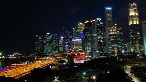SINGAPORE - OCTOBER 22 2019: flight over night illuminated singapore city downtown marina traffic road aerial panorama 4k circa october 22 2019 singapore.