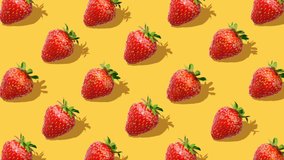 Beautiful background from  of large group of red juicy strawberries berries. Fresh juicy strawberry rotating on yellow background. Flat lay, top view. Isometric view. Seamless loop video. 