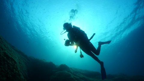 silhouette female scuba diver sun beam shine rays underwater lady woman diver relaxing blue ocean scenery of person