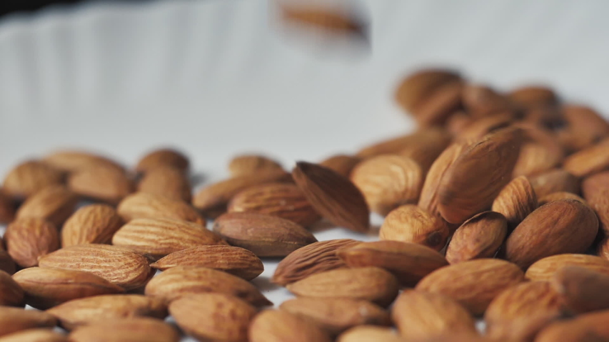 Almonds rotation on the white background - falling  Royalty-Free Stock Footage #1055191463