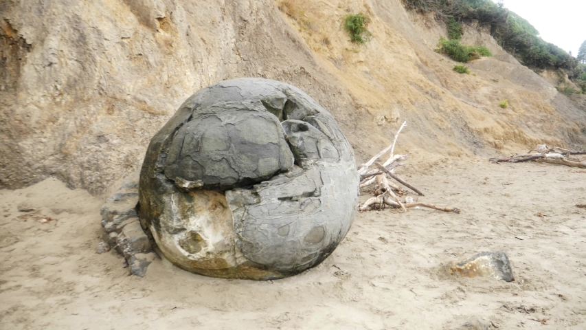 The Moeraki Boulders are unusually large and spherical boulders lying along a stretch of Koekohe Beach on the wave-cut Otago coast of New Zealand 