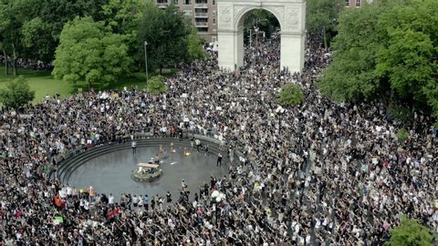 NEW YORK - JUNE 6, 2020: protestors yelling Black Lives Matter and power to the people - demonstrators chanting in Washington Square Park rally under arch, Manhattan NYC.
