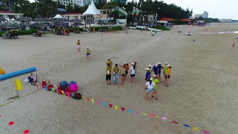 VUNG TAU , VIETNAM -  May 15th, 2020:  Aerial view of tourists playing team building on the beach  on Vung Tau beach at  Vung Tau  city, Vietnam.