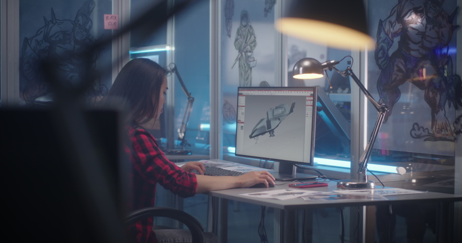 Medium shot of a female designer creating 3D aircraft model for a video game Royalty-Free Stock Footage #1055207540