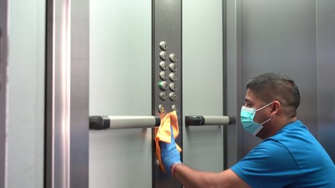 Cleaning professional thoroughly disinfecting elevator push buttons