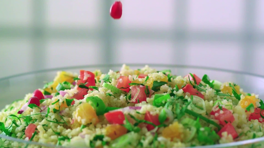 Delicious bulgur pilaf with vegetables and chickpeas.Slow motion video.