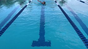 Active Senior Woman Swimming Laps in a Lap Pool
