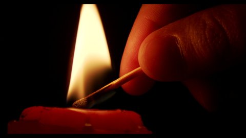 Match Lighting Close-up Macro With Single Candle Flame Isolated on Black Background In Slow Motion