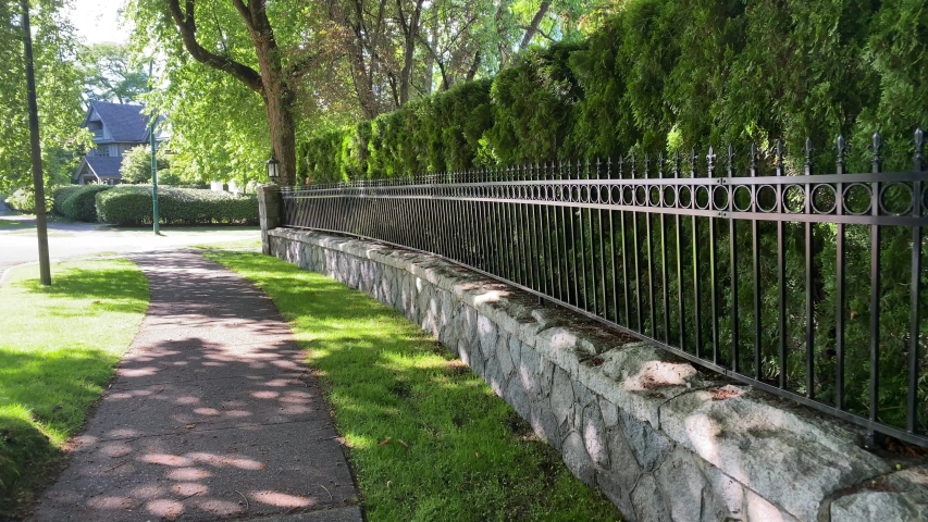Fence built from trees and stones. Outdoor landscape. Security and privacy concept. Vancouver. Canada.