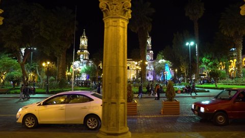 AREQUIPA, PERU. DEC 2019. Night view of the main square and the Cathedral of Arequipa. Some people stroll and have fun in the plaza.