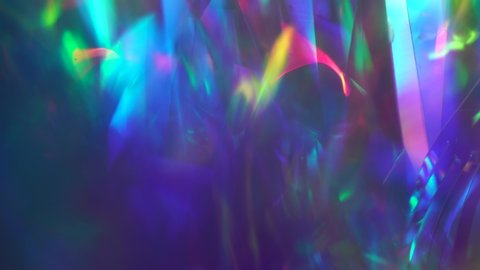 Crystal prism refracting light in vivid rainbow colors. Diamond neon purple holographic background