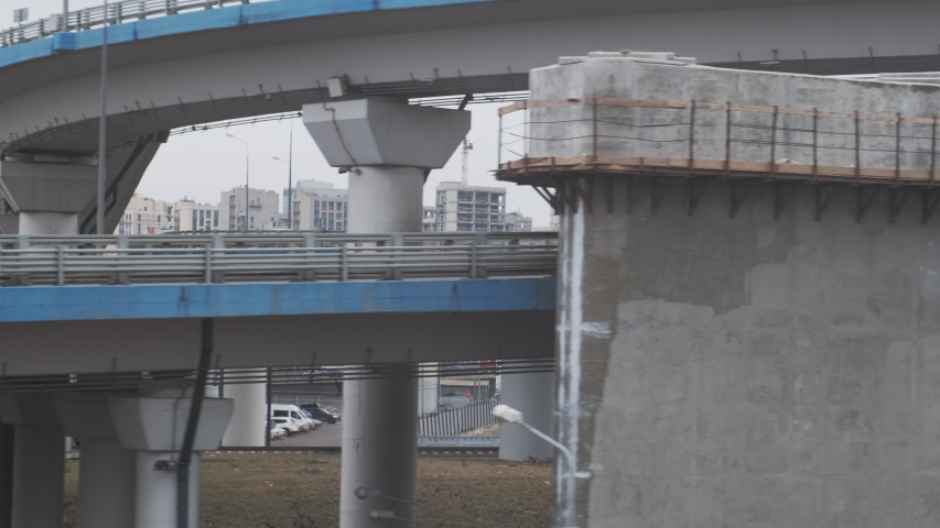 Looking out the window of the train while another train zooms and mooving fast.