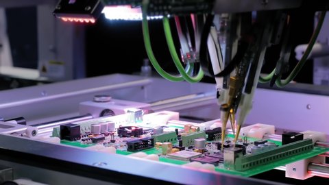 Automated technology, industrial, robotic, electronic, production, manufacturing concept. Automation machine equipment for quality testing of printed circuit boards - flying probe test - close up