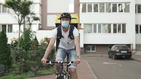 Courier delivery of food by bicycle during an outbreak of the virus. Coronavirus, COVID-19, safe delivery. - Powered by Shutterstock - Get 15% off with code: PIKWIZARD15