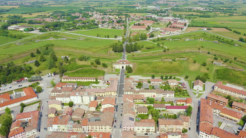 Inscription on video. Palmanova, Udine, Italy. An exemplary fortification project of its time was laid down in 1593. Neon white effect text, Aerial View