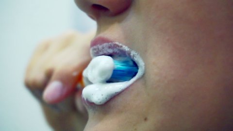 oral hygiene.teenager brushes teeth with toothpaste.mouth close up