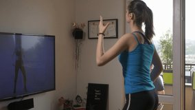 Woman exercise while watching streaming classes