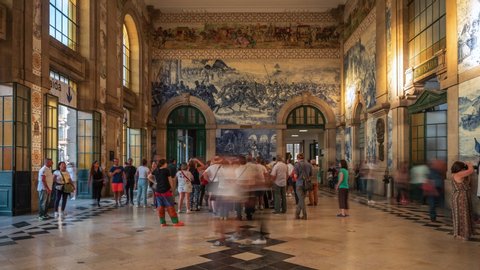 Porto, Portugal - September 02: Timelapse view of people at the entrance hall of architectural landmark Sao Bento Railway Station in the heart of the Historic Centre in Porto, Portugal. 